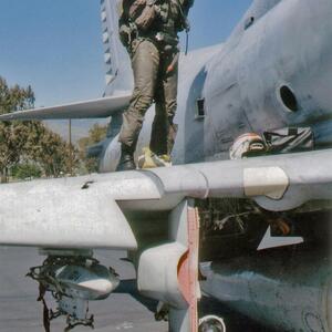 Close-up as unidentified pilot suits up on the wing of VMA-214 Blacksheep A-4M Skyhawk BuNo 160022
